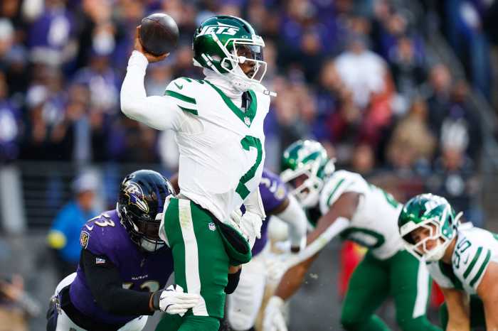 Jets player Tyrod Taylor gets tackled by Ravens