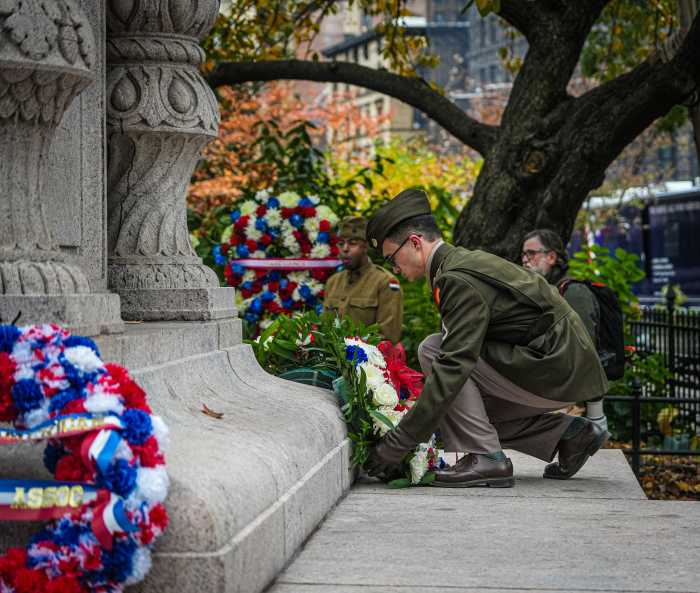 A soldier lays a wreath at the NYC Veterans Day Parade in Midtown on Nov. 11, 2025.