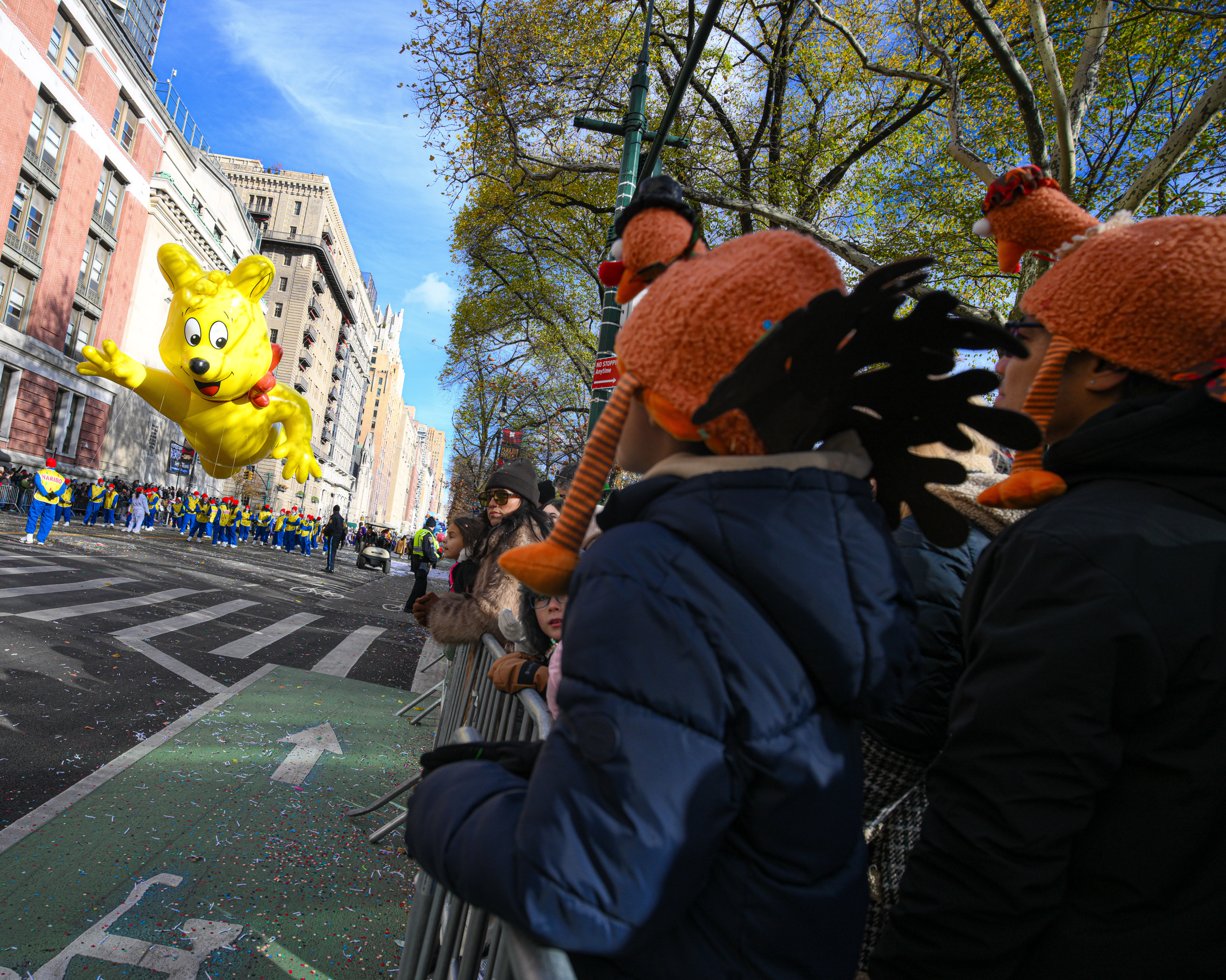 Spectators watch the Haribo gummy bear go by.