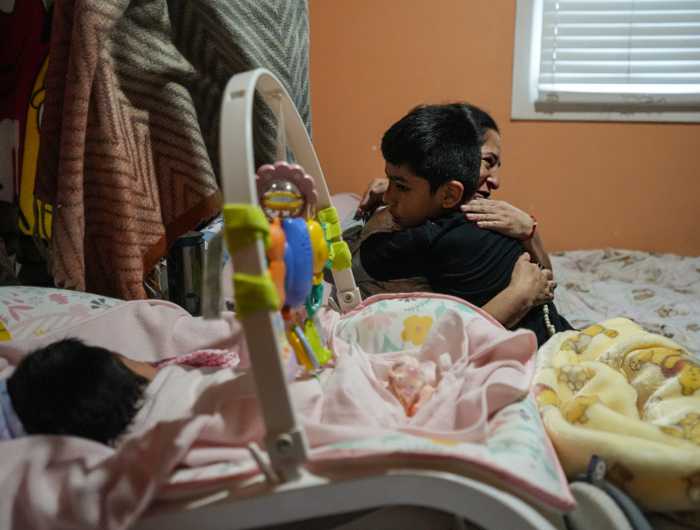 Queens mom hugs her son with baby girl in foreground after dad abducted by ICE