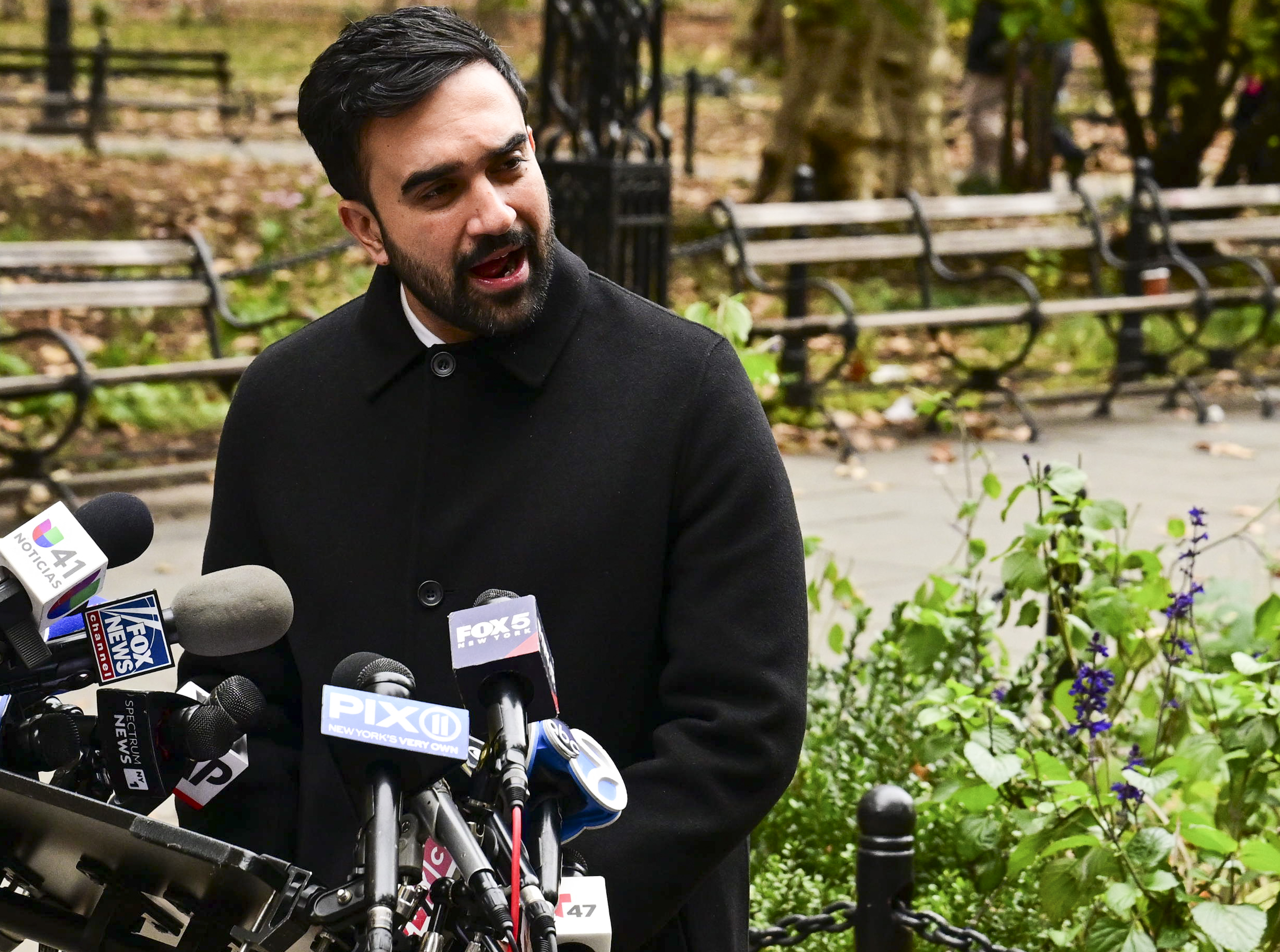 Mayor-elect Zohran Mamdani speaking at microphones