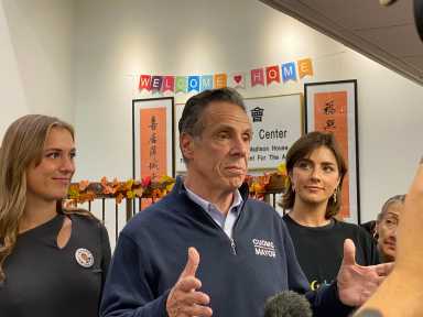 Former Gov. Andrew Cuomo speaks to reporters at the Chinatown Senior Center in Manhattan on Monday, joined by his daughters Michaela and Mariah, during the final day of his independent campaign for New York City mayor.