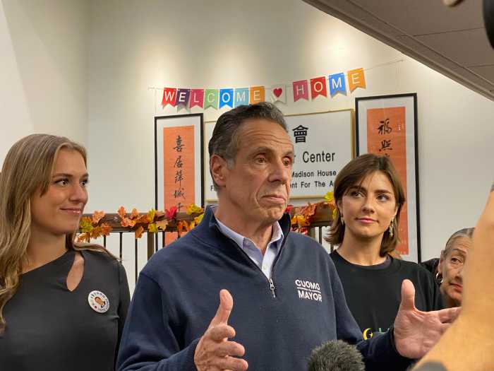 Former Gov. Andrew Cuomo speaks to reporters at the Chinatown Senior Center in Manhattan on Monday, joined by his daughters Michaela and Mariah, during the final day of his independent campaign for New York City mayor.