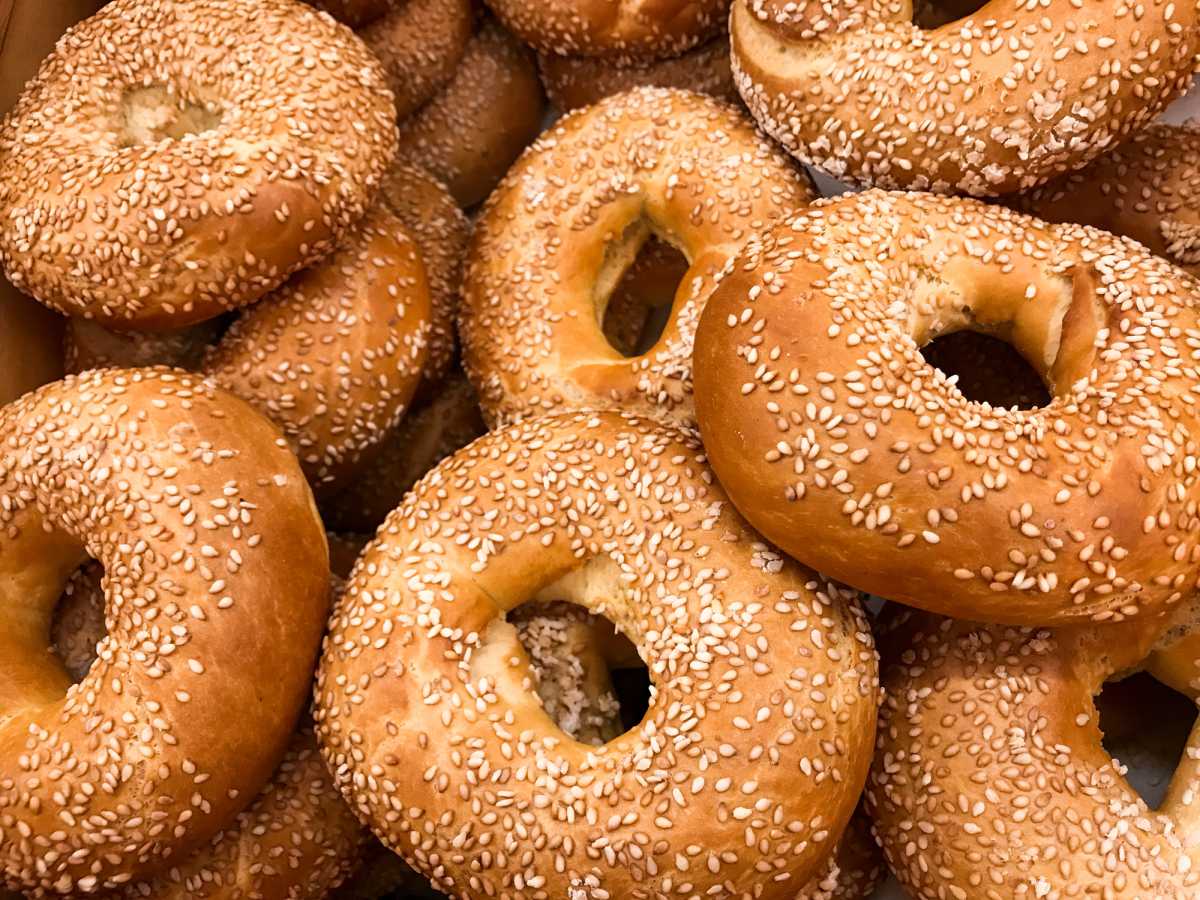 Close-up of a pile of freshly baked bagels sprinkled with sesame seeds