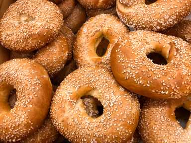 Close-up of a pile of freshly baked bagels sprinkled with sesame seeds