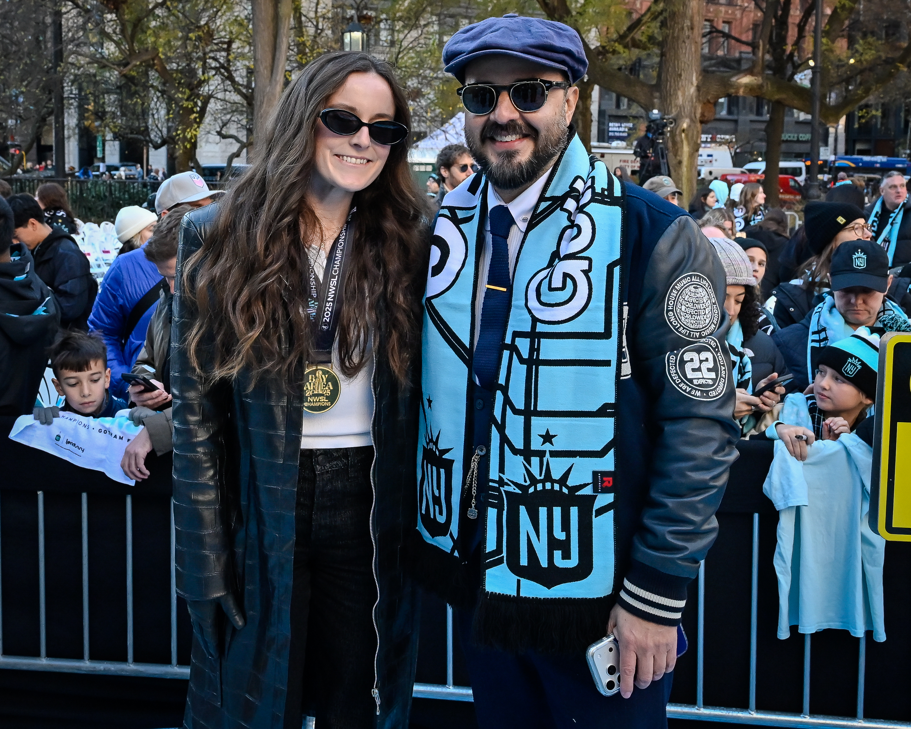 Rose Lavelle and Counci Member Francisco Moya celebrate Gotham FC's championship. 