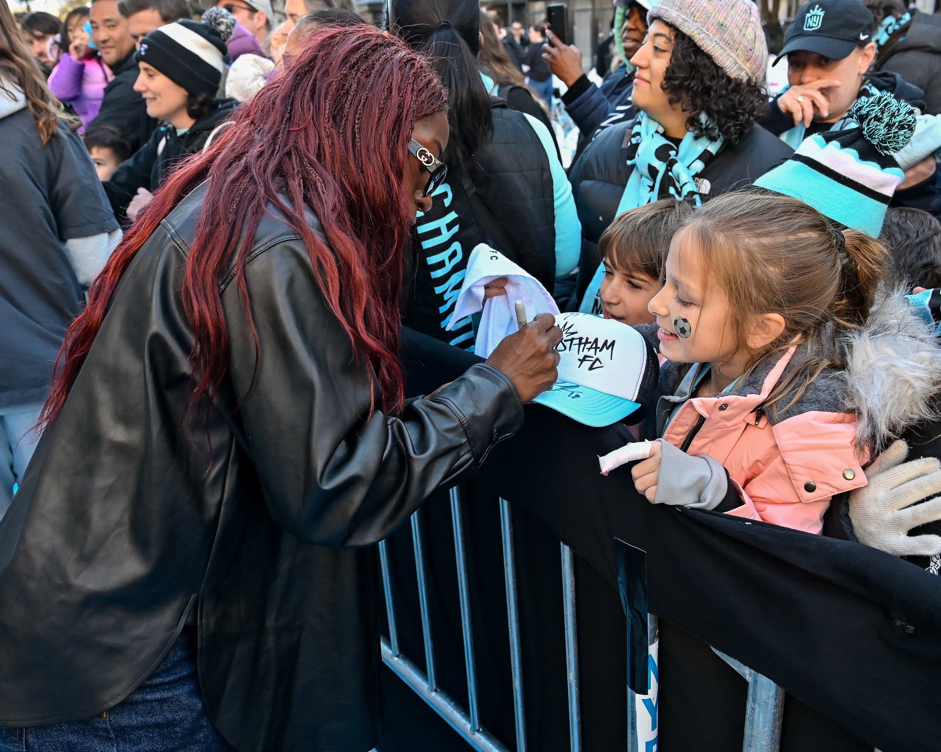 Gotham FC player Mandy Freeman signs autographs for fans after the ceremony.