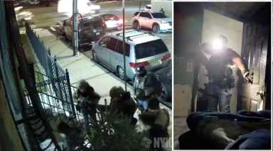 Still from video shared by the New York Immigration Coalition shows ICE agents attempting to enter a basement apartment in Elmhurst, Queens, on Nov. 13. In the footage, one agent shines a flashlight at a mother as she pleads that her baby is in bed with her.