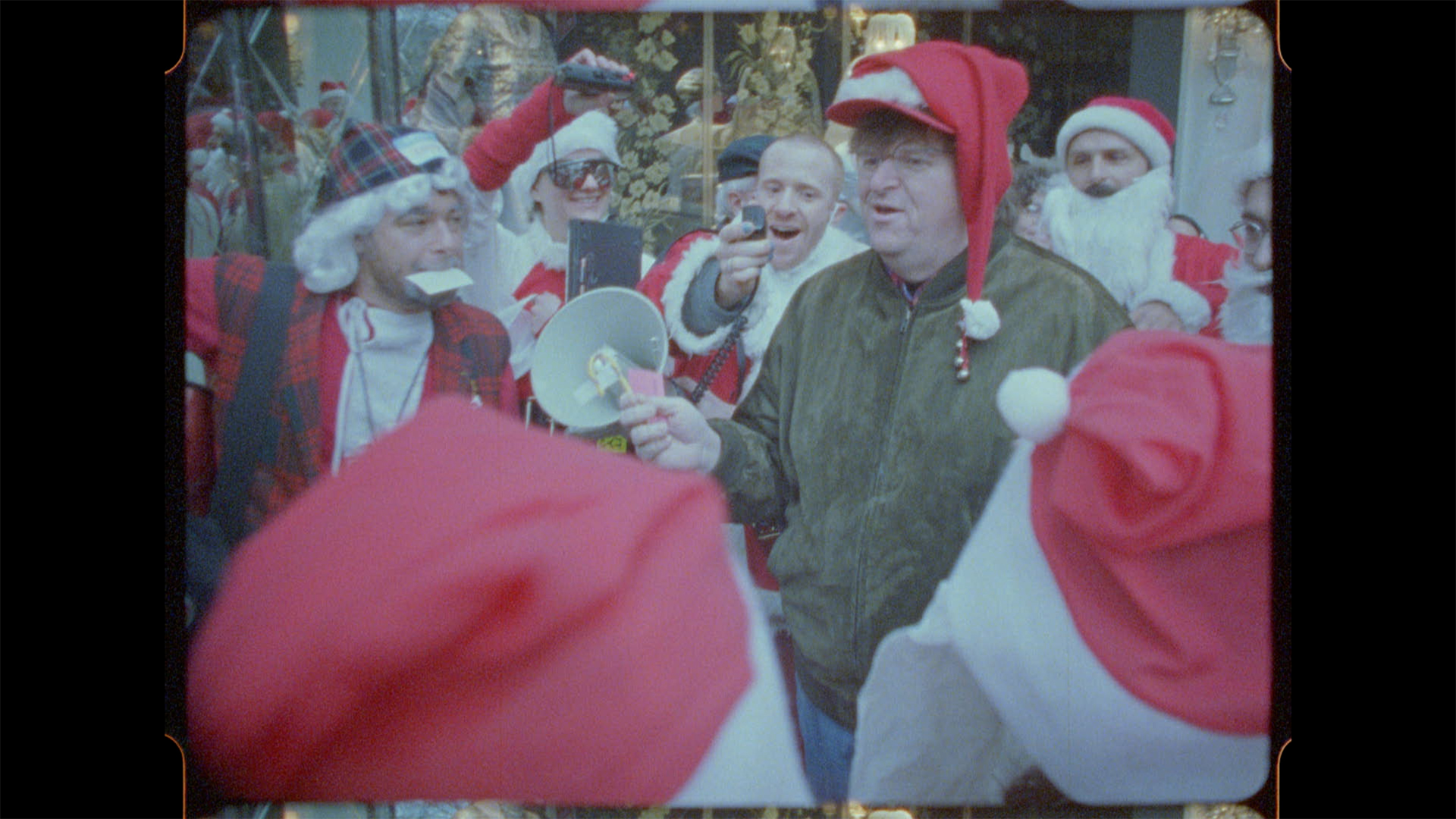 The Santas sing Christmas carols with Michael Moore in New York in 1998, the first year the
event invaded the city.