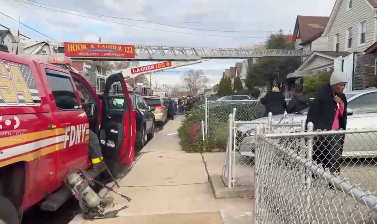 firefighters in Queens at scene of house fire