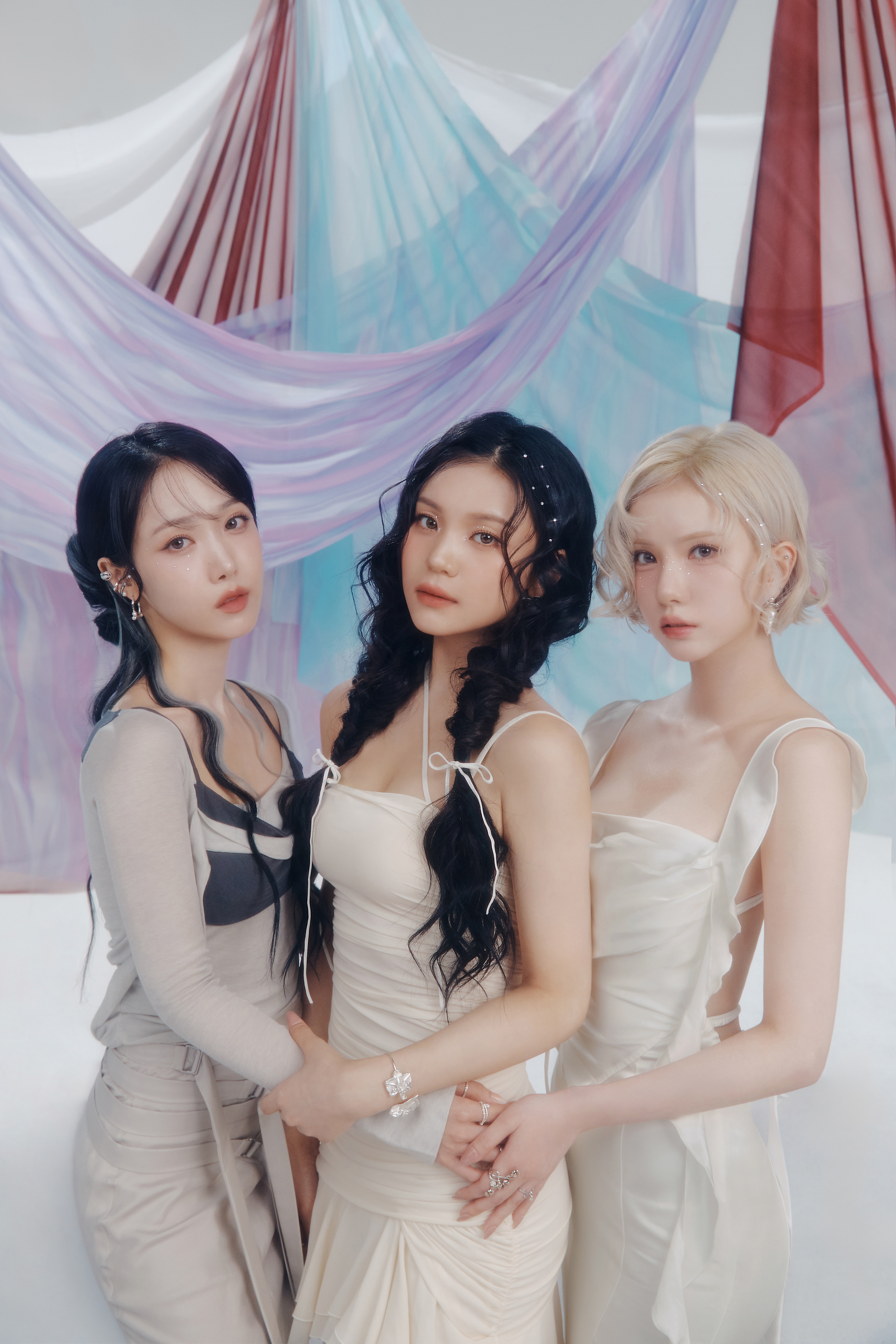 VIVIZ the k-pop girl group. Three women standing near each other.
