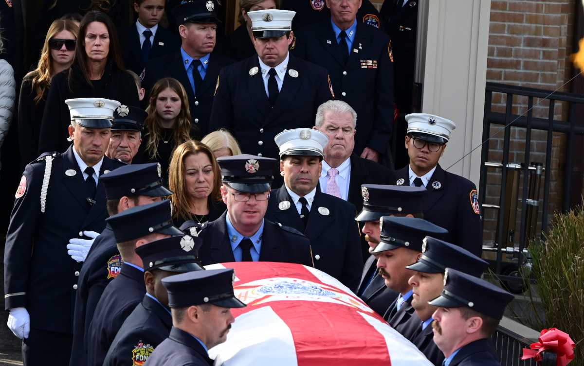 firefighters carry the coffin of FDNY Lieutenant Patrick Brady