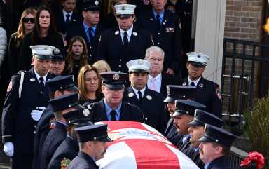 firefighters carry the coffin of FDNY Lieutenant Patrick Brady