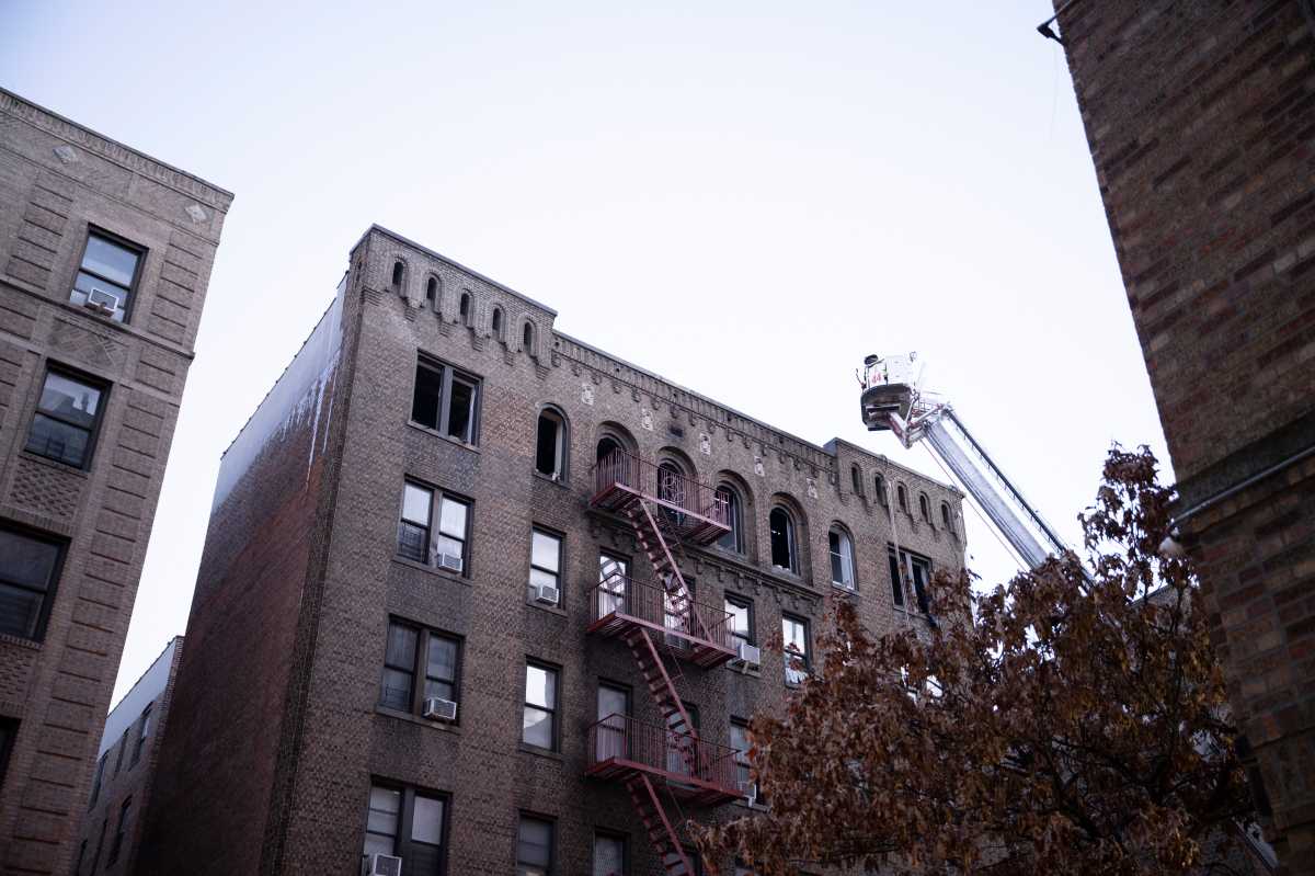 Bronx firefighters working on roof of burning apartment building