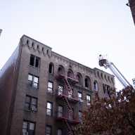 Dead woman found in Bronx apartment fire; nine firefighters and cops injured in blaze 19 Bronx firefighters working on roof of burning apartment building