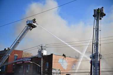a firefighter putting out a fire during the day