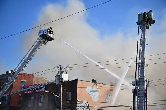 a firefighter putting out a fire during the day