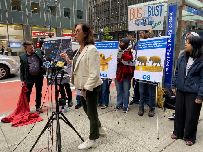 people outside at a podium with signs