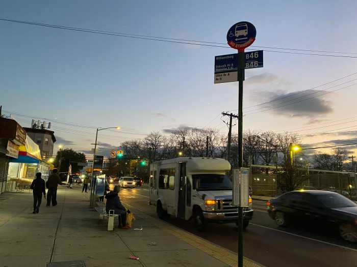 a bus stop in Brooklyn at dusk