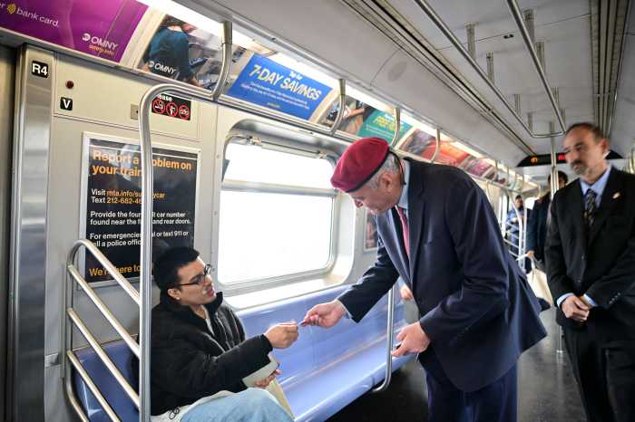 NYC Mayor's Race: One more ride for the red beret, as Curtis Sliwa campaigns to the very end 3 people on a subway train