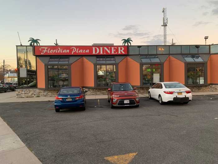 exterior of a diner showing its parking lot