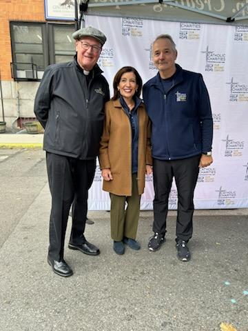 two men and a woman, each wearing jackets