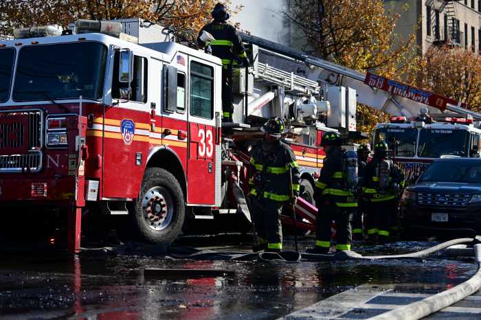 fire truck and firefighters during the day