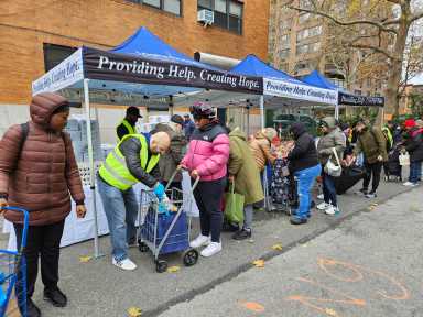 people on line at a food distribution event