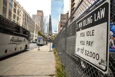 buses parked on a street and idling