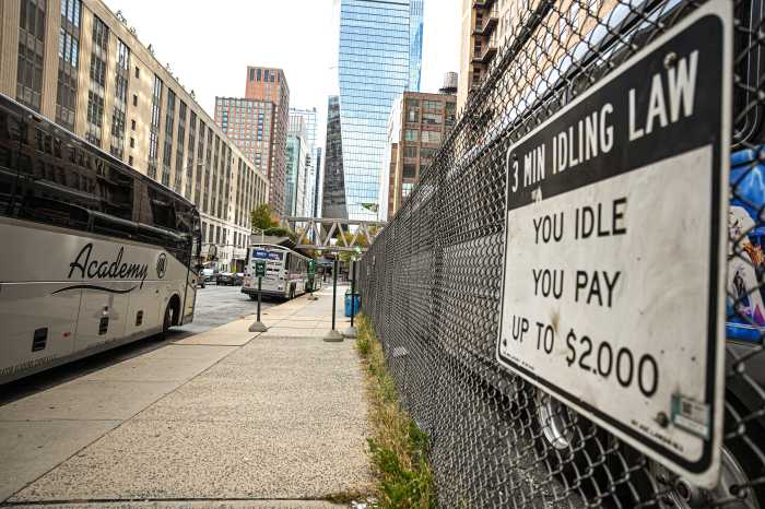buses parked on a street and idling