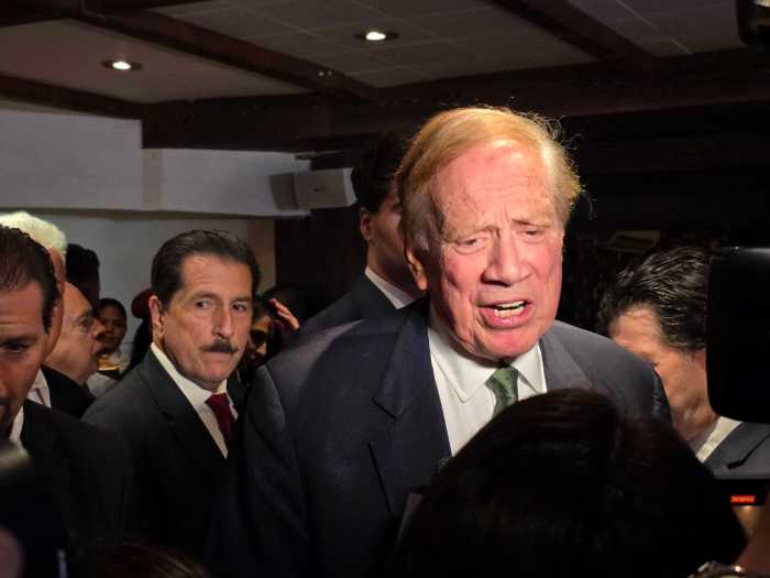 people wearig dark suits iin a dark room