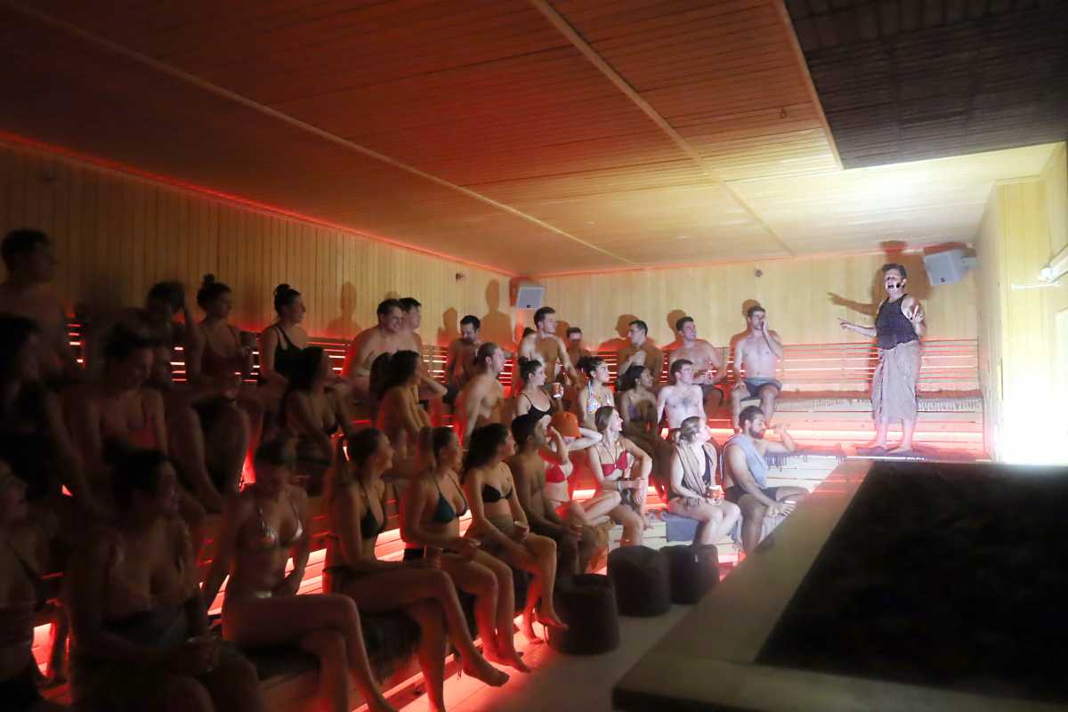 people at Sauna Comedy enjoy hearing jokes from performer