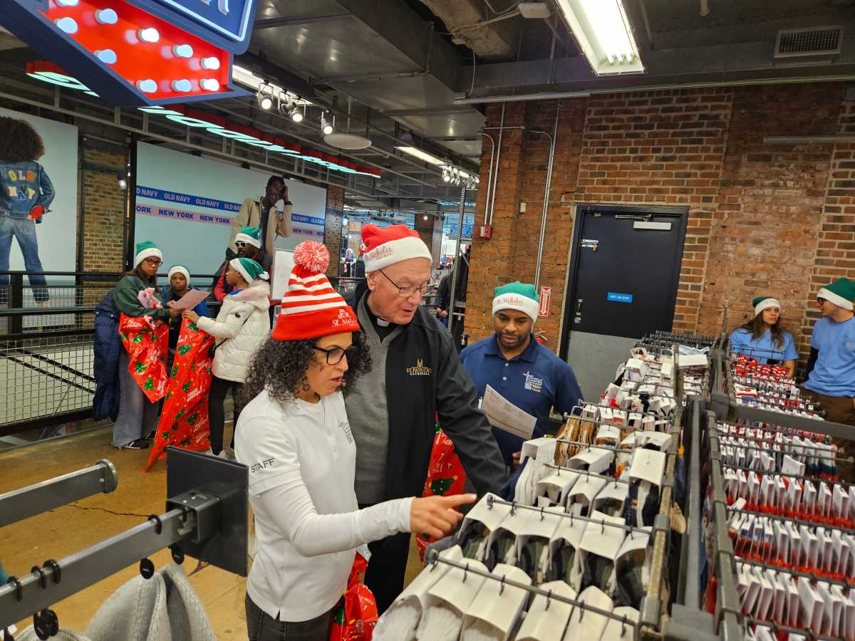 Cardinal Timothy Dolan, hundreds of volunteers, drop by NYC Old Navy to shop for strangers 2 Cardinal Dolan shopping with holiday gifts at Old Navy with New Yorkers in need