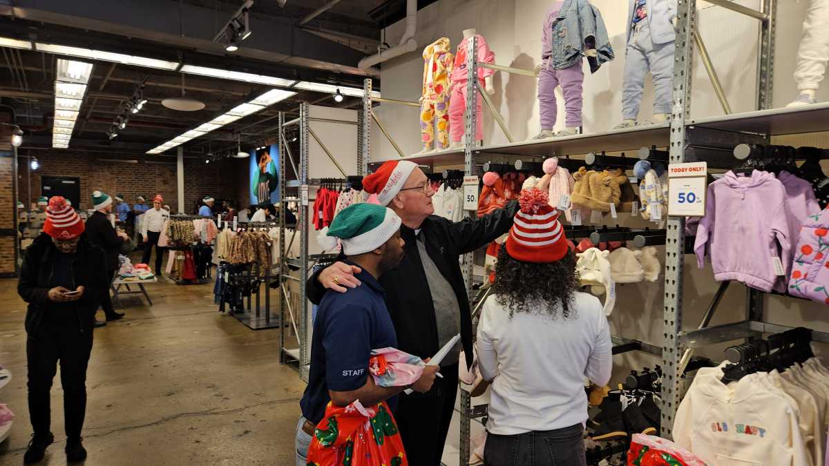 Cardinal Timothy Dolan, hundreds of volunteers, drop by NYC Old Navy to shop for strangers 3 Cardinal Dolan shopping at Old Navy