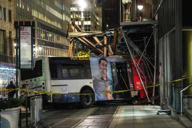 large bus crash into scaffolding in Midtown