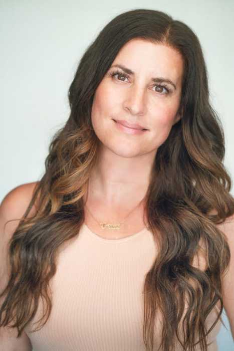woman with long hair and a beige shirt
