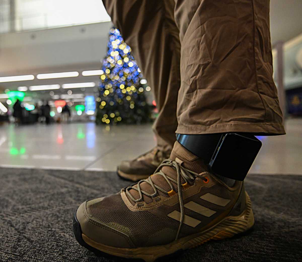 close up of an ankle monitor on a man who was detained by ICE 