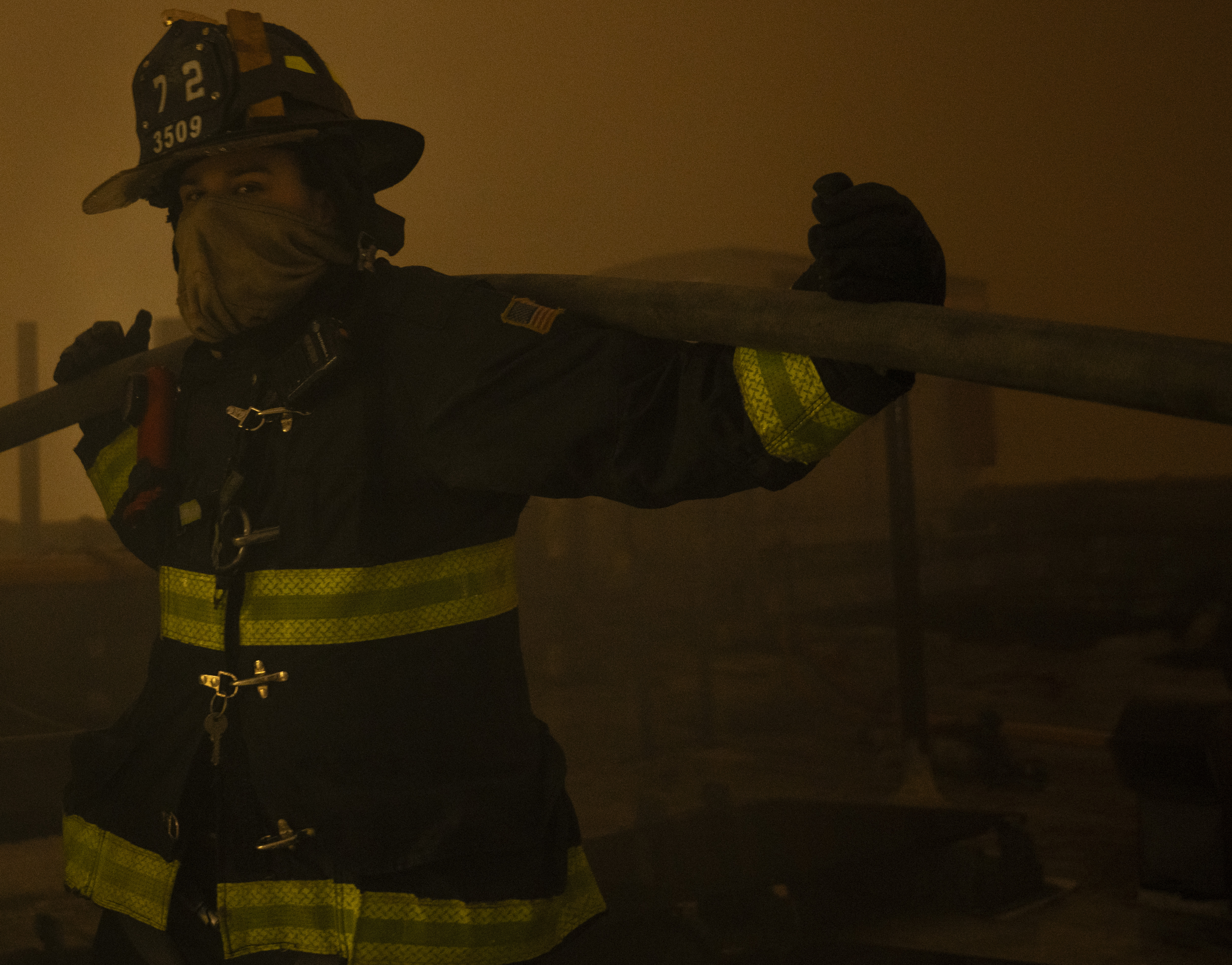 Five-alarm fire rips through Bronx buildings: FDNY 5 A firefighter from Engine Company 72 operates a hoseline during a five alarm fire at 558 Prospect Avenue.