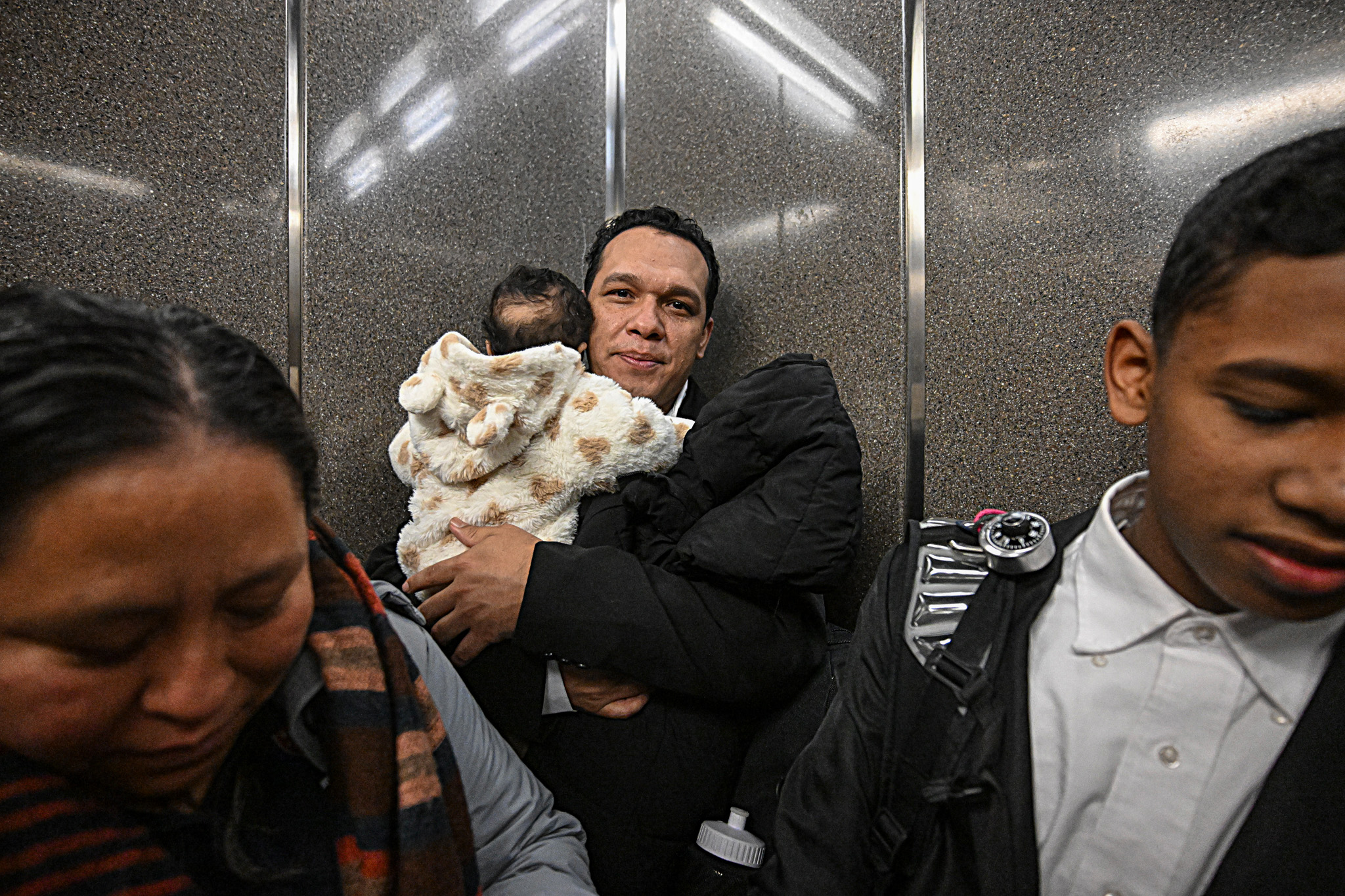 family member holding infant after meeting with ICE at Federal Plaza