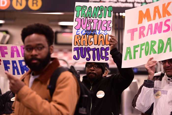 'Make the buses free!' Transit advocates rally in Brooklyn demanding that Mamdani make good on his key transit promise 2 people inside a subway station holding signs