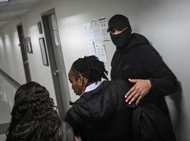 Masked ICE agent takes detainee at federal plaza court