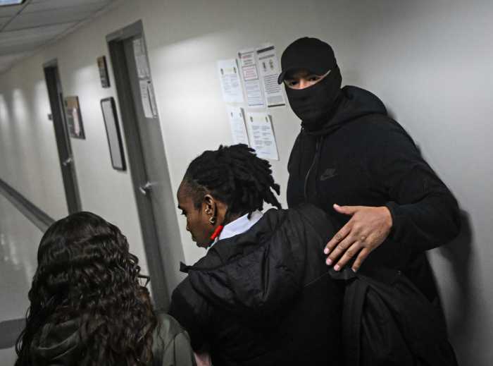 Masked ICE agent takes detainee at federal plaza court