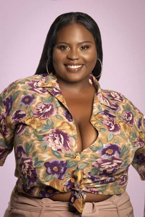 woman with dark hair and multi-colored shirt