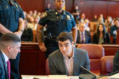 Luigi Mangione, wearing a suit jacket in a courtroom
