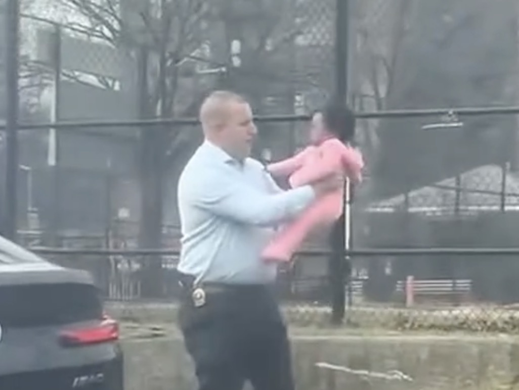 NYPD detective with choking baby whom he rescued
