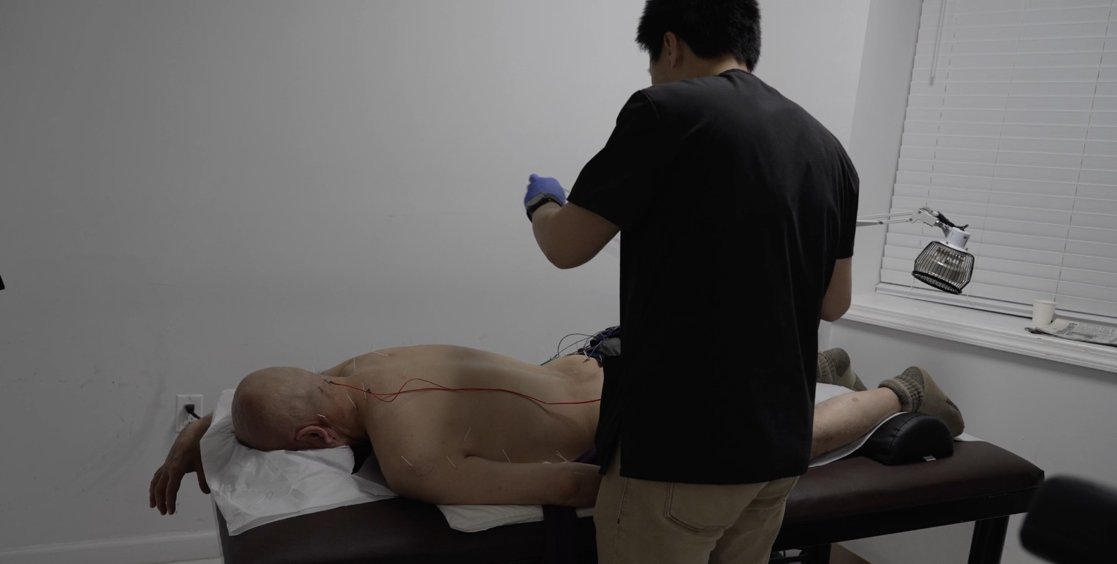 Dr. Cai Bin works on a patient.