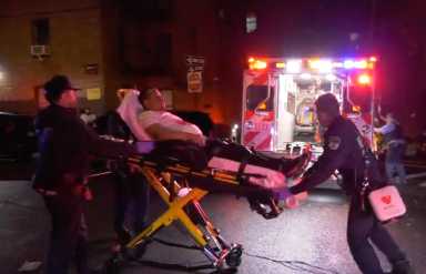 victim in bronx shooting being placed in ambulance by ems