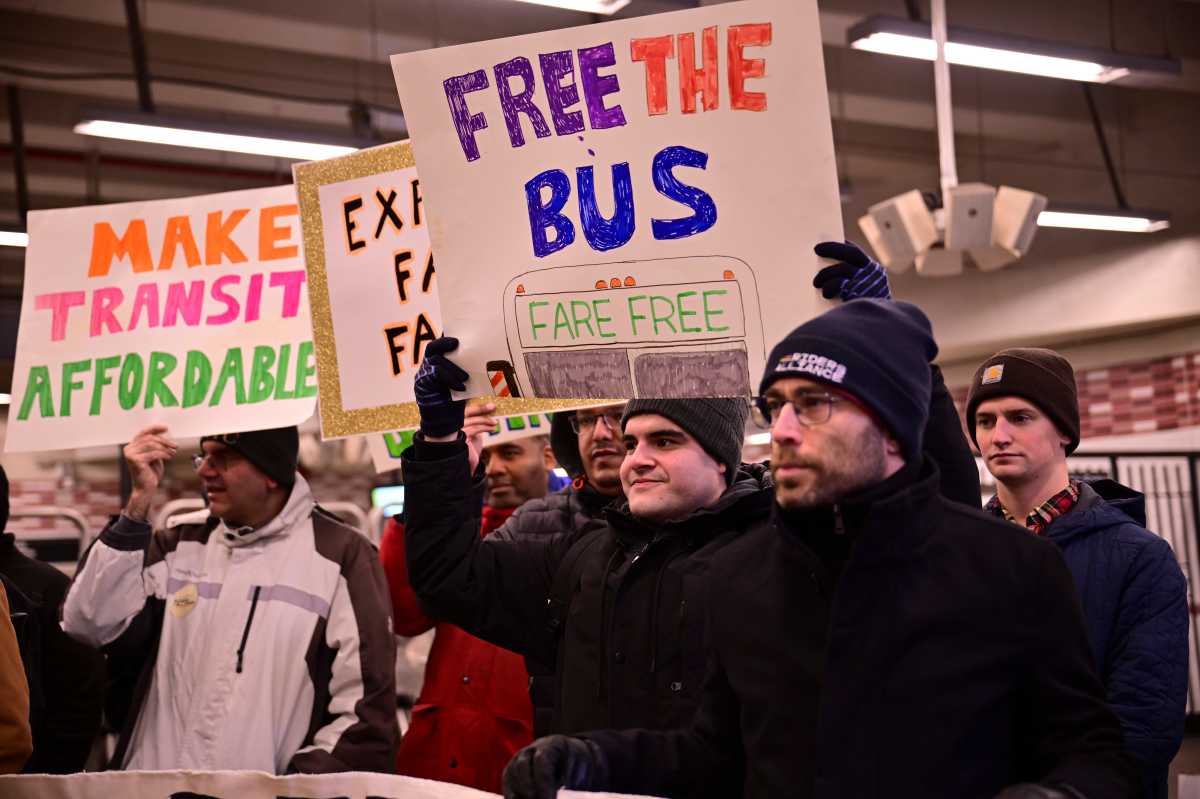 group of people in winter coats holding signs