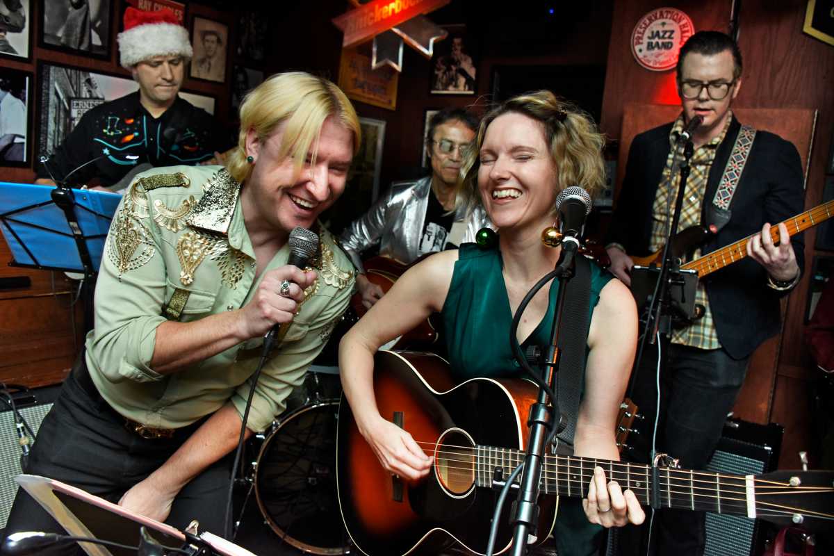 two people singing at East Village country music holiday show