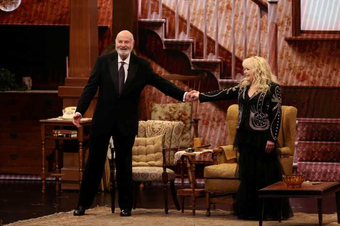 two actors on a stage set that resembles a home